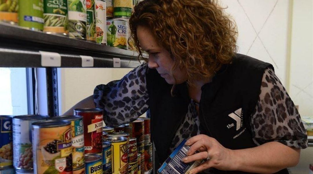 A woman preparing canned goods at a food bank