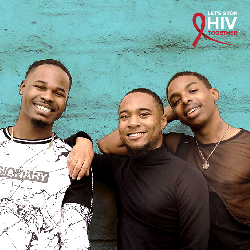 A photo of three young black men smiling and in brotherhood